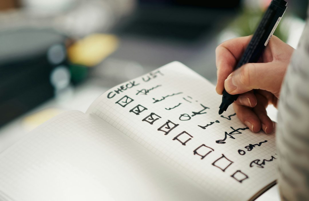 Someone checking items off a checklist, representing due diligence before hiring an SEO agency